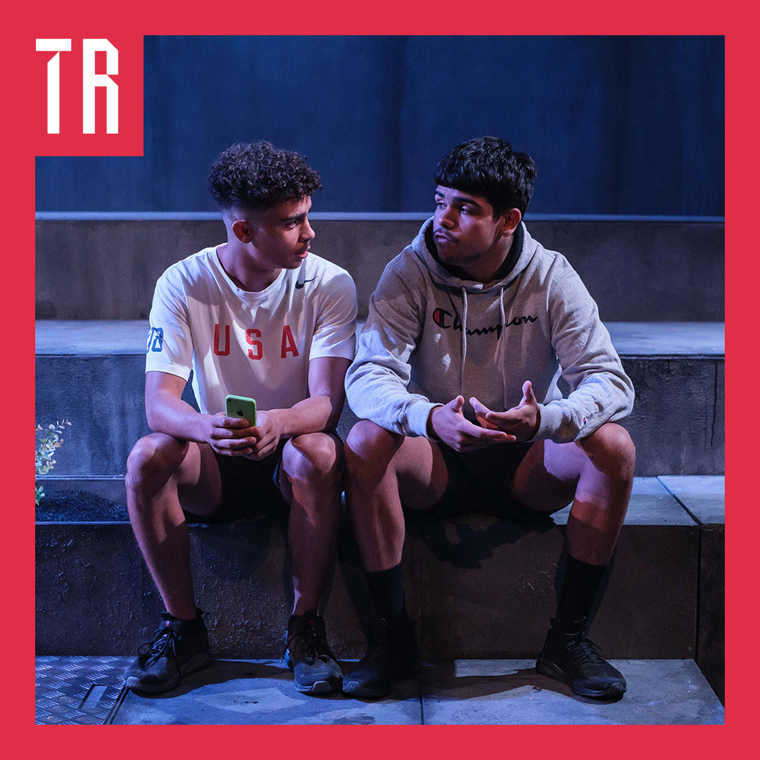 Photo: Clare Hawley Two teenage First Nations boys sit on a step, they are deep in conversation