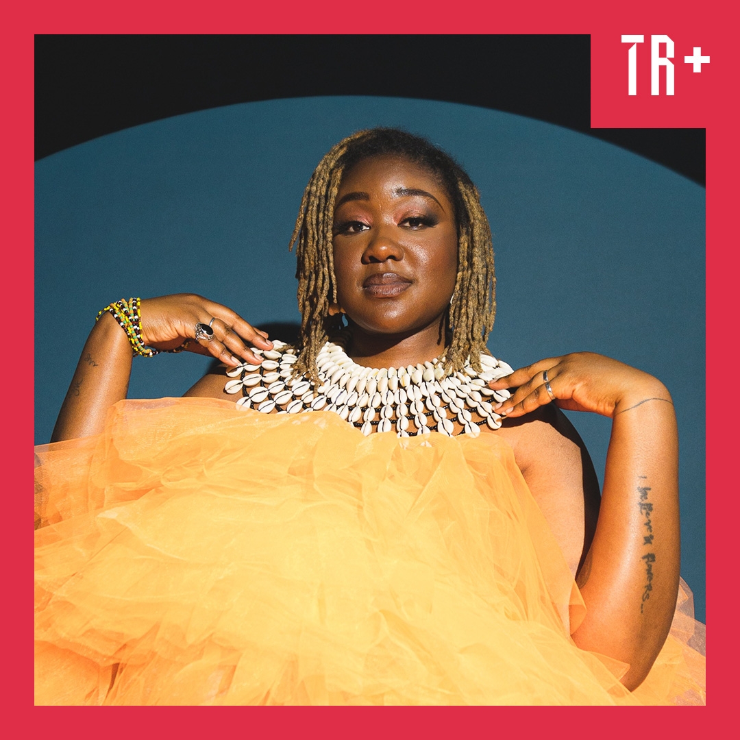 Image: Ibrahim Intwari A portrait of Nancy Denis, an African Australian performer. She is wearing a yellow tule dress and a striking necklace (like a collar) of shells