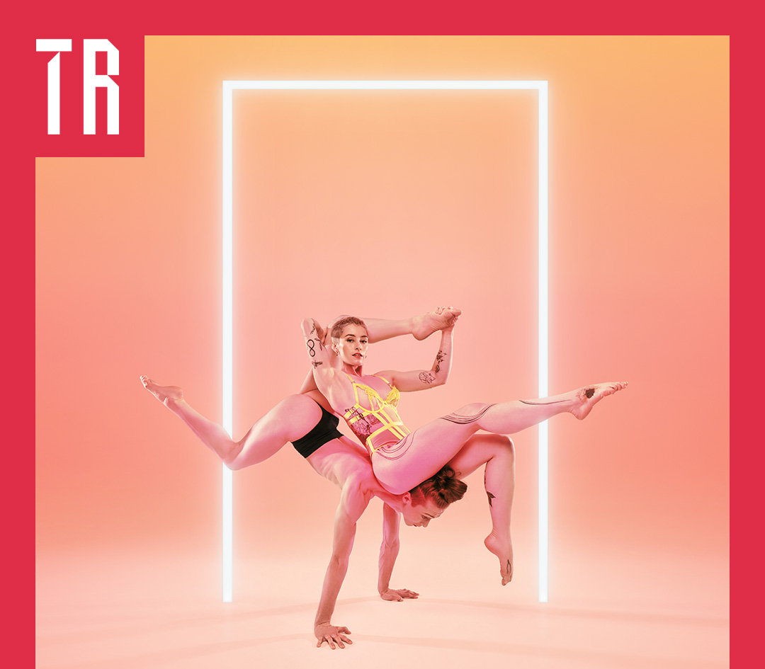 Photo: Denis Koone Two female acrobats balance precariously against each other