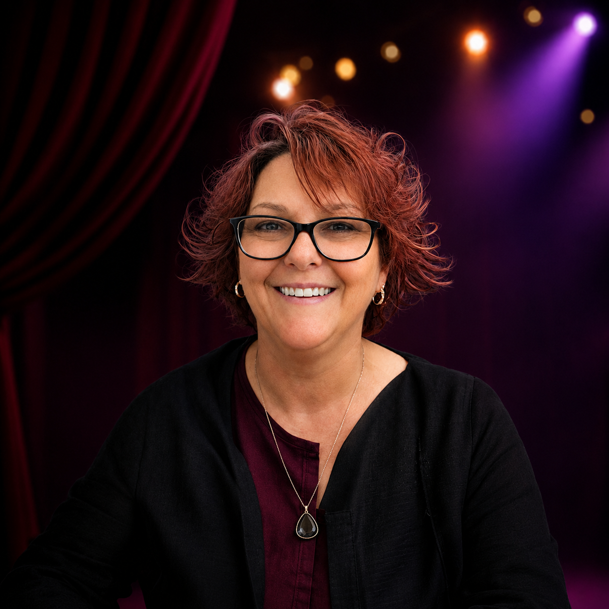 Image: supplied Portrait of Donna Young - a smailing woman with black rimmed glasses and short wavey auburn hair